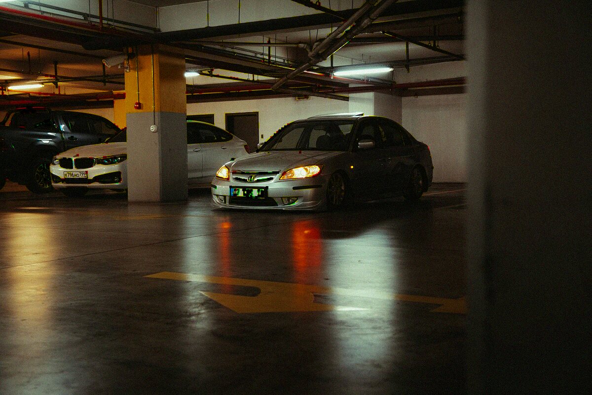 Security patrol vehicle in a dimly lit Orlando parking structure at night